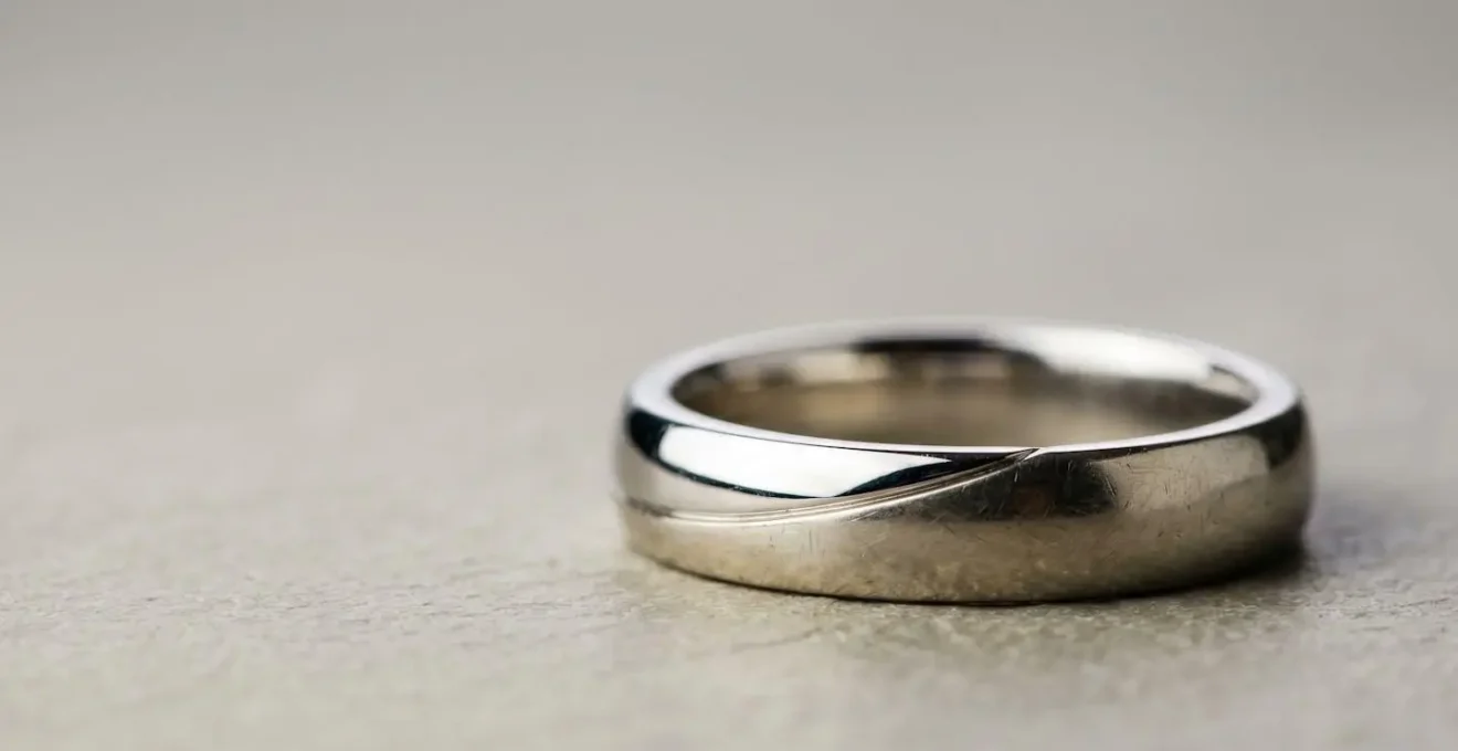 Bague en or blanc montrant la patine naturelle après le port quotidien, illustrant le jaunissement progressif du rhodiage usé